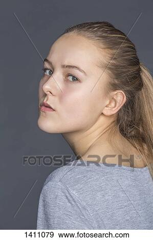 Side view portrait of confident teenage girl against gray background View Large Photo Image Stock Photo - Side view portrait of confident teenage girl against gray background. Fotosearch