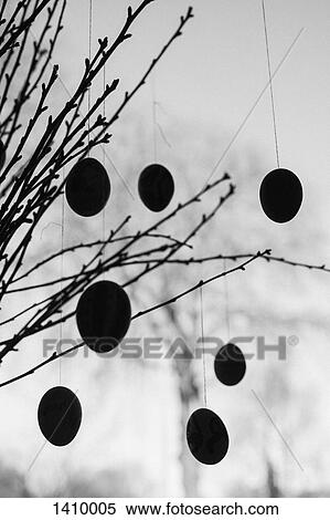 Silhouette decorations hanging on bare branches against sky View Large Photo Image Stock Photography - Silhouette decorations hanging on bare branches against sky. Fotosearch