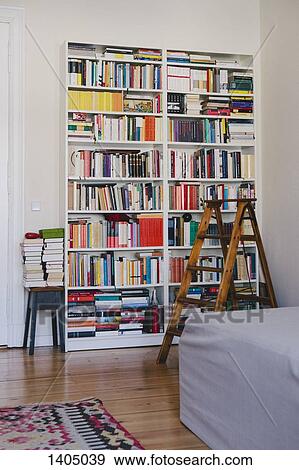 Stock Photo - Step ladder near bookshelves at home. Fotosearch