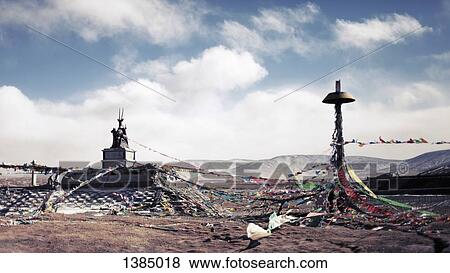 Stock Photo - "Tangled bunting on mountain against cloudy sky, Yushu Tibetan Autonomous Prefecture, China". Fotosearch