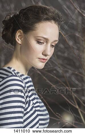 Stock Image - Thoughtful woman looking down. Fotosearch