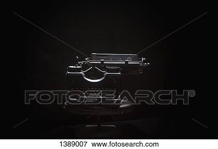 Typewriter on table against black background View Large Photo Image Stock Photo - Typewriter on table against black background. Fotosearch