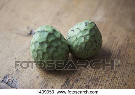 Whole cherimoyas on wooden table View Large Photo Image Stock Image - Whole cherimoyas on wooden table. Fotosearch