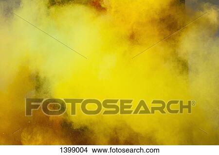 Picture - Yellow powder paint spraying during Holi festival. Fotosearch