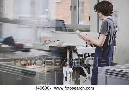 Young man working with equipment in a factory View Large Photo Image Stock Photo - Young man working with equipment in a factory. Fotosearch