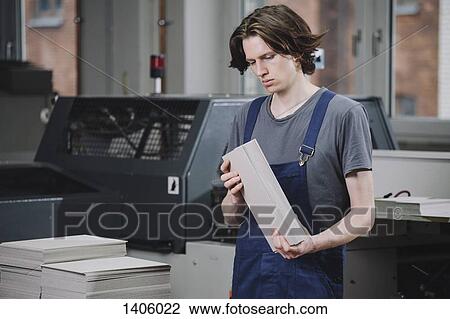 Young manual worker examining cardboard sheets in factory View Large Photo Image Stock Image - Young manual worker examining cardboard sheets in factory. Fotosearch