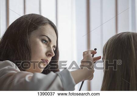 Young woman applying make-up to friend View Large Photo Image Stock Photo - Young woman applying make-up to friend. Fotosearch