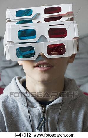 A boy wearing a large amount of 3-D glasses View Large Photo Image Stock Image - A boy wearing a large amount of 3-D glasses. Fotosearch