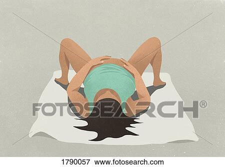 A pregnant woman lying down on a blanket View Large Photo Image Stock Photo - A pregnant woman lying down on a blanket. Fotosearch