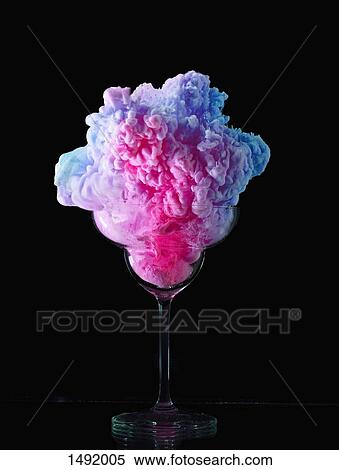 Stock Photography - Abstract image of multi colored frozen yogurt in glass against black background. Fotosearch