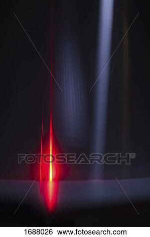 Stock Photograph - Abstract image of red and gray light trails over black background. Fotosearch