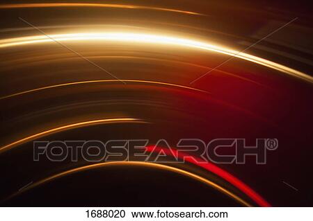 Stock Image - Abstract image of vibrant light trails against black background. Fotosearch