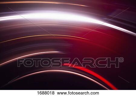 Stock Photo - Abstract image of vibrant red light trails against black background. Fotosearch