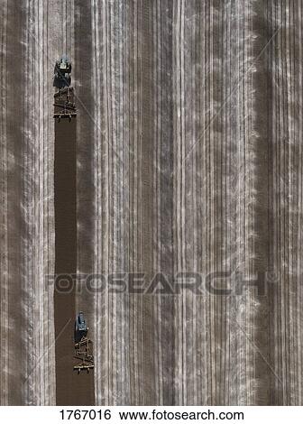 Aerial view agricultural tractors plowing field, Bakersfield, California, USA View Large Photo Image Stock Photograph - Aerial view agricultural tractors plowing field, Bakersfield, California, USA. Fotosearch
