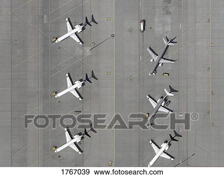Stock Photo - Aerial view airplanes parked on tarmac at airport. Fotosearch