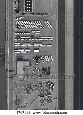 Stock Image - Aerial view buses and cars parked at airport. Fotosearch
