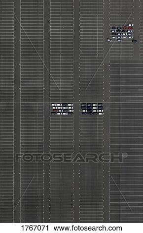 Stock Image - Aerial view cars in sunny parking lot. Fotosearch