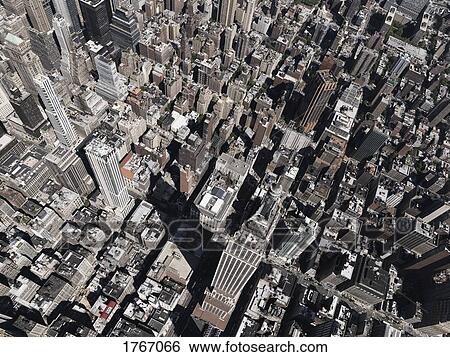 Aerial view Empire State Building towering above sunny city, New York City, New York, USA View Large Photo Image Stock Photograph - Aerial view Empire State Building towering above sunny city, New York City, New York, USA. Fotosearch