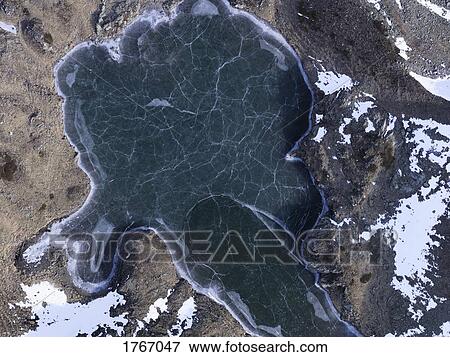 Aerial view frozen glacial lake, Ischgl, Tyrol, Austria View Large Photo Image Stock Photo - Aerial view frozen glacial lake, Ischgl, Tyrol, Austria. Fotosearch