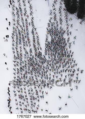 Aerial view large group of skiers on snowy slope, St. Moritz, Switzerland View Large Photo Image Stock Photo - Aerial view large group of skiers on snowy slope, St. Moritz, Switzerland. Fotosearch