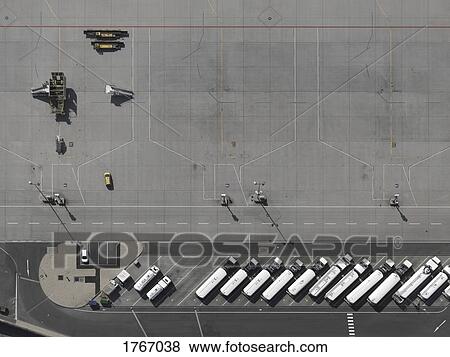 Stock Photo - Aerial view service vehicles parked on tarmac at airport. Fotosearch