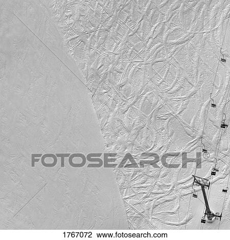 Stock Image - Aerial view ski tracks pattern on snowy ski slope, Hochjoch, Vorarlberg, Austria. Fotosearch