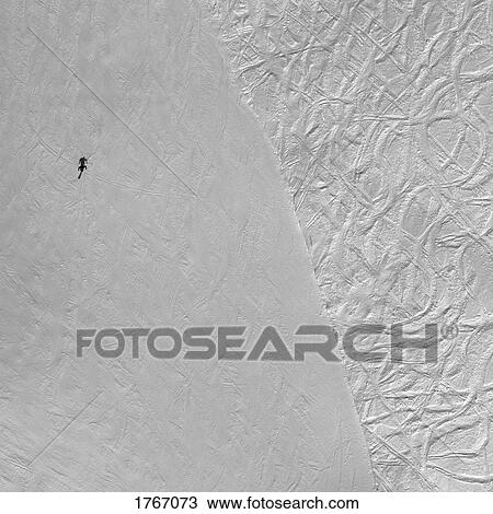 Stock Image - Aerial view skier on snowy ski slope, Hochjoch, Vorarlberg, Austria. Fotosearch