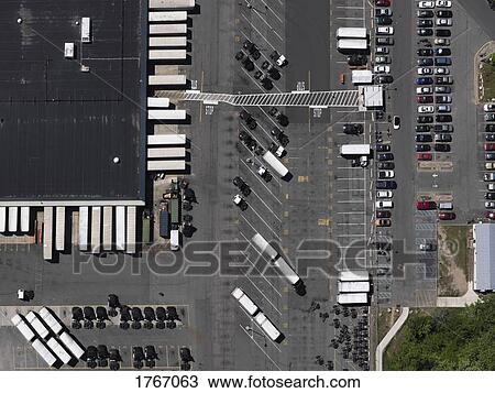 Stock Image - Aerial view sunny parking lot and commercial warehouse, New York City, New York, USA. Fotosearch