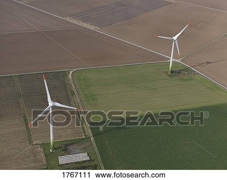 Stock Image - Aerial view wind turbines in agricultural fields near Frankfurt, Hessen, Germany. Fotosearch