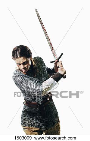 Angry woman wearing chain mail holding sword against white background View Large Photo Image Stock Photo - Angry woman wearing chain mail holding sword against white background. Fotosearch