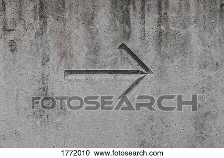 Stock Image - Arrow on concrete wall. Fotosearch