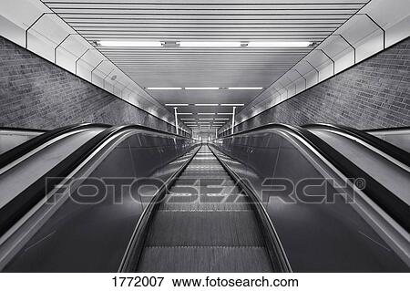 Black and white of descending escalator View Large Photo Image Stock Photo - Black and white of descending escalator. Fotosearch