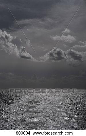 Picture - Black and white storm clouds over ocean. Fotosearch