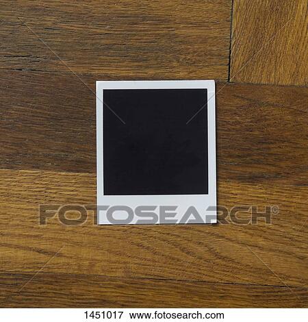 Blank instant camera print on wooden table View Large Photo Image Stock Photo - Blank instant camera print on wooden table. Fotosearch