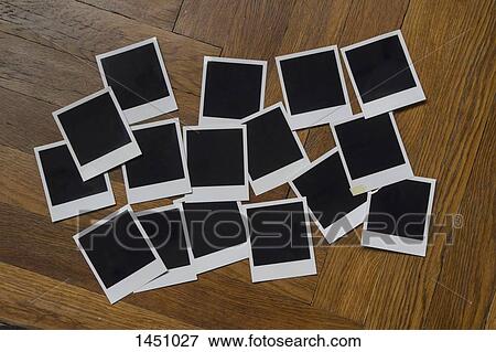 Blank instant camera prints on wooden table View Large Photo Image Stock Photo - Blank instant camera prints on wooden table. Fotosearch