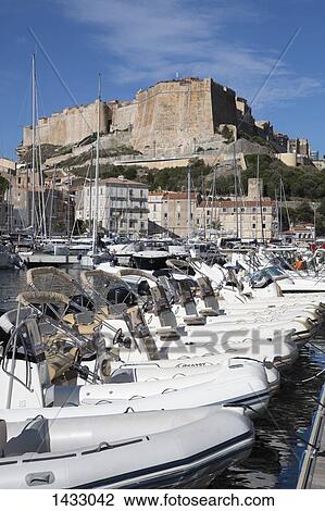 Boats moored at Bonifacio Harbor against sky View Large Photo Image Stock Image - Boats moored at Bonifacio Harbor against sky. Fotosearch