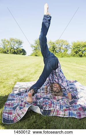 Boy practicing headstand at backyard during sunny day View Large Photo Image Stock Image - Boy practicing headstand at backyard during sunny day. Fotosearch