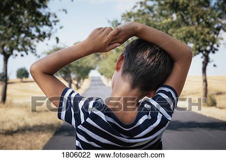 Boy standing on rural road View Large Photo Image Stock Image - Boy standing on rural road. Fotosearch