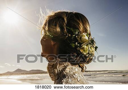 Bride with flowers in hair on sunny ocean beach View Large Photo Image Stock Image - Bride with flowers in hair on sunny ocean beach. Fotosearch