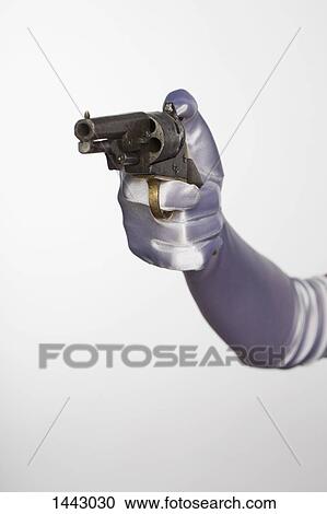 Stock Image - Bride's hand holding handgun against white background. Fotosearch
