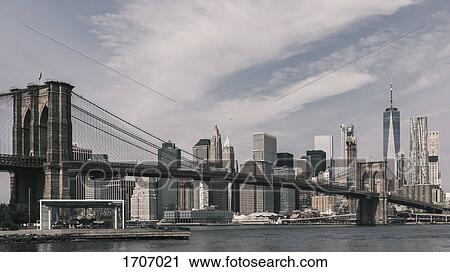 Stock Image - Brooklyn Bridge Over East River against Manhattan skyline, New York City, New York, USA. Fotosearch