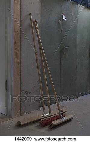Brooms leaning against wall in workshop View Large Photo Image Stock Photo - Brooms leaning against wall in workshop. Fotosearch