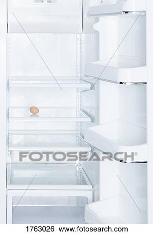 Brown egg in open, empty white refrigerator View Large Photo Image Stock Photograph - Brown egg in open, empty white refrigerator. Fotosearch