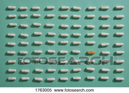 Brown pill standing out from crowd of capsules on green background View Large Photo Image Stock Photography - Brown pill standing out from crowd of capsules on green background. Fotosearch