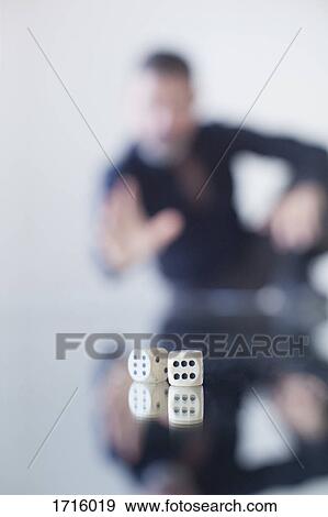 Businessman rolling dice on glass table View Large Photo Image Stock Photo - Businessman rolling dice on glass table. Fotosearch
