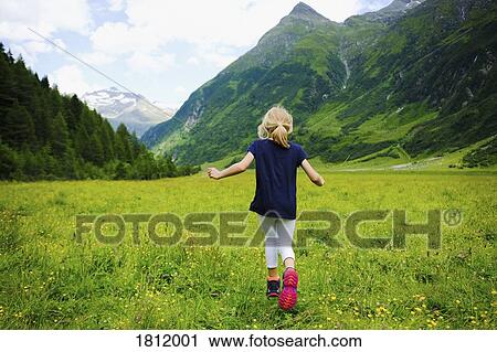 Carefree girl running in idyllic mountain valley, Innergschloess, Tyrol, Austria View Large Photo Image Stock Image - Carefree girl running in idyllic mountain valley, Innergschloess, Tyrol, Austria. Fotosearch