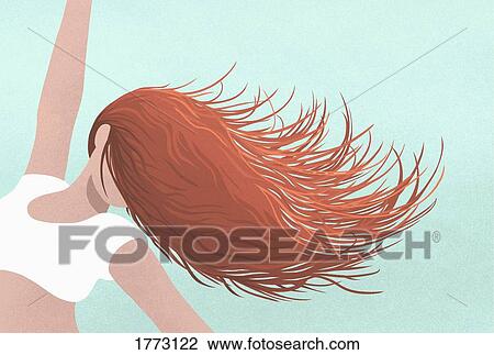 Stock Image - Carefree woman dancing, flipping hair over face. Fotosearch