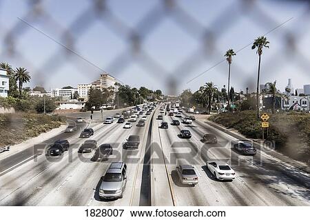 Cars driving along sunny freeway, Los Angeles, California, USA View Large Photo Image Stock Photo - Cars driving along sunny freeway, Los Angeles, California, USA. Fotosearch
