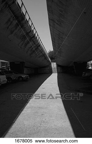 Cars parked under overpass on sunny day View Large Photo Image Stock Photography - Cars parked under overpass on sunny day. Fotosearch