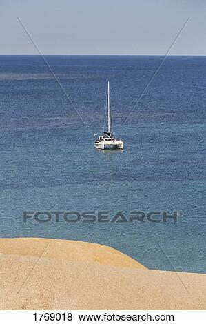 Catamaran on sunny, tranquil ocean, Port Willunga, South Australia, Australia View Large Photo Image Stock Photo - Catamaran on sunny, tranquil ocean, Port Willunga, South Australia, Australia. Fotosearch